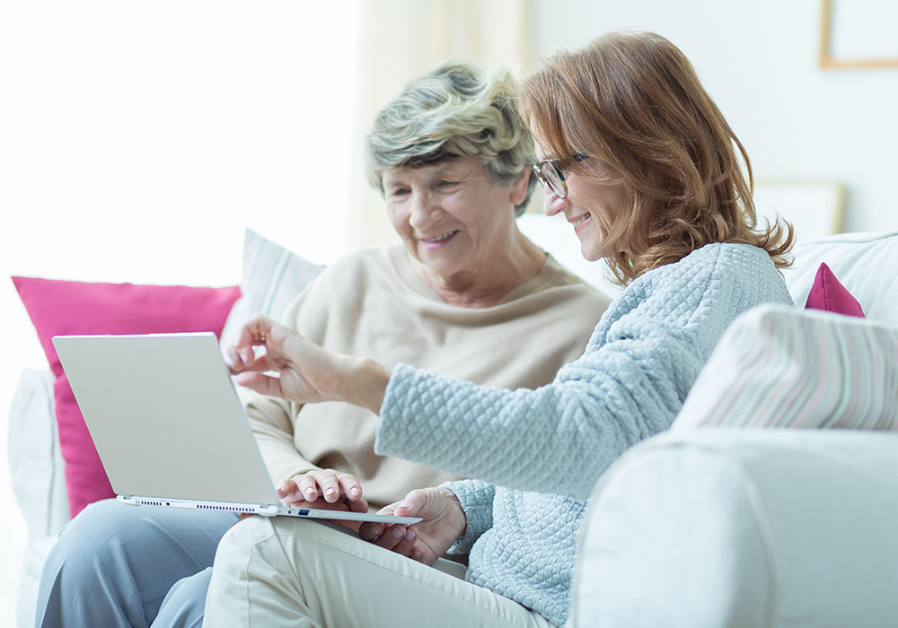 Young woman and mother looking at laptop